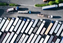 GXO extends transport partnership with Co-op for five years white parked trucks