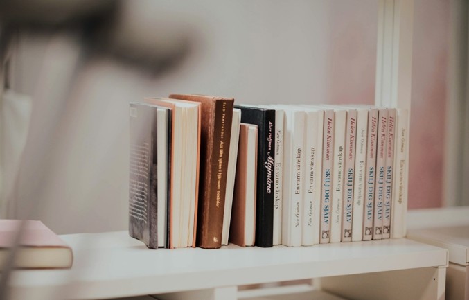 Books lined up on a white shelf, illustrating recommended reading on Japan-Korea relations, geopolitical strategy, regional security, and historical memory