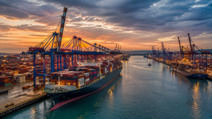 Container ships and cranes at a major North European port amid industrial action affecting German ports and Rotterdam.
