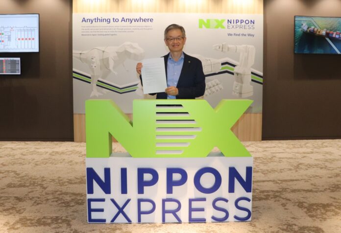 NIPPON EXPRESS HOLDINGS Senior Managing Executive Officer Satoshi Otsuji holding the signed MOU