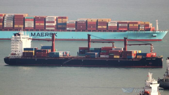 Mariana Express container ship Rabaul Chief sailing alongside a larger Maersk vessel.