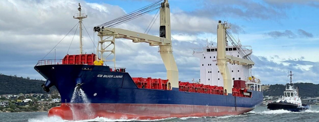 ICS Silver Lining: ICS Silver Lining sailing near the coast with a tugboat alongside.